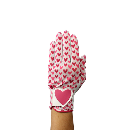 Ladies golf glove with red and pink heart pattern