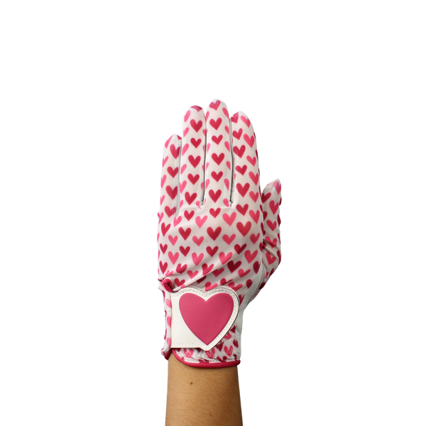 Ladies golf glove with red and pink heart pattern