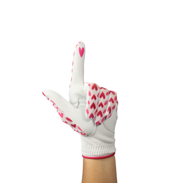 Ladies golf glove with red and pink heart pattern